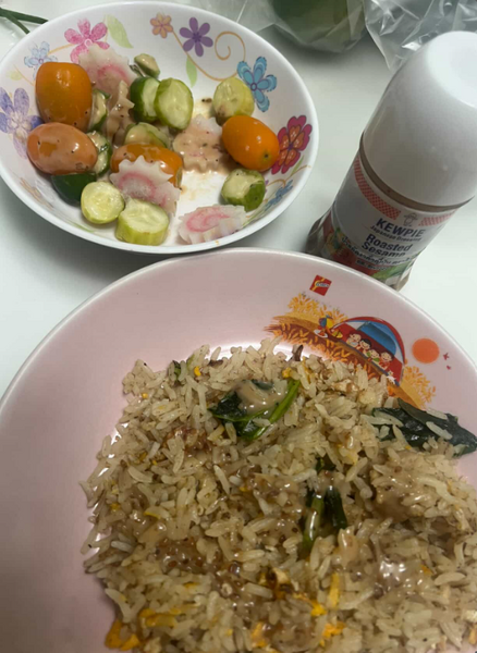 Fried rice with tomato and cucumber salad topped with fish balls — insanely delicious!